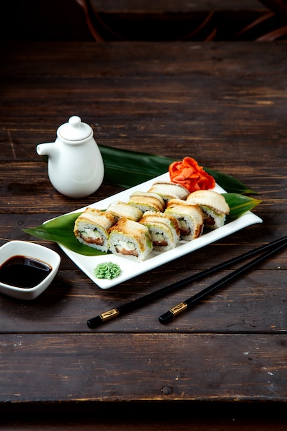 Sushi rolls on plate with soy sauce