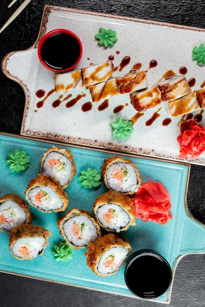 Free photo sushi rolls served with wasabi ginger and soy sauce