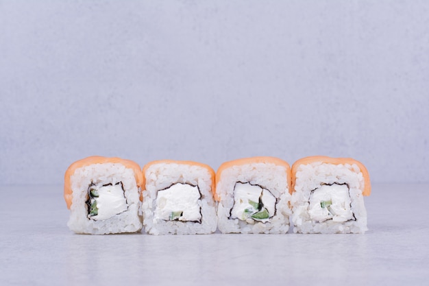 Sushi rolls with cream cheese on grey background