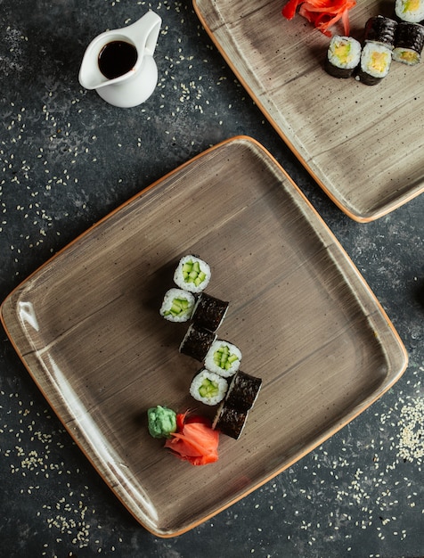 Sushi rolls with cucumber served with ginger and  wasabi