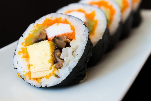 Sushi set in a row on a plate