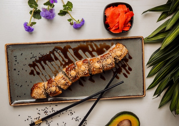 Sushi set under sauce on the table