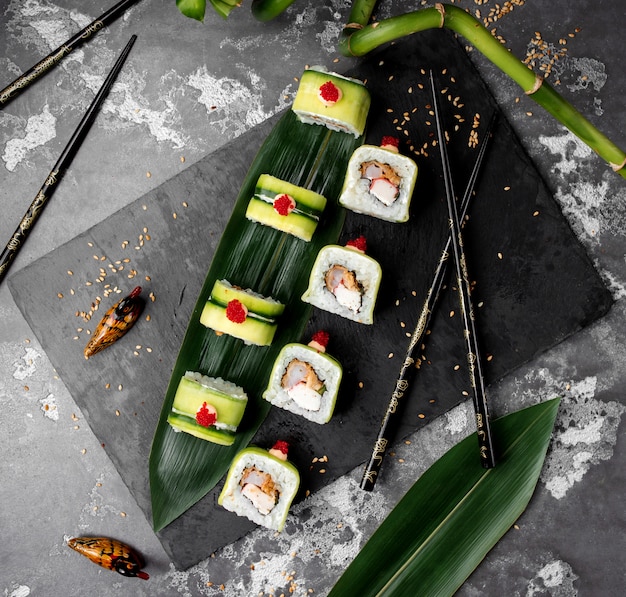 Free photo sushi set with cucumber on the table