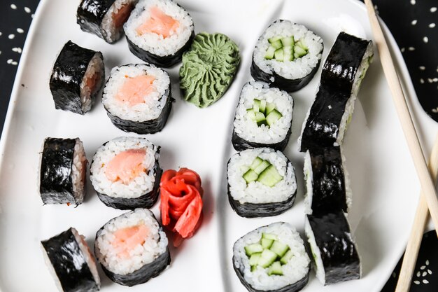 Sushi set with salmon cucumber rice sesame top view