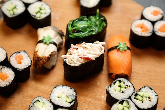 Sushi set with various types of sushi pn wooden desk close-up view