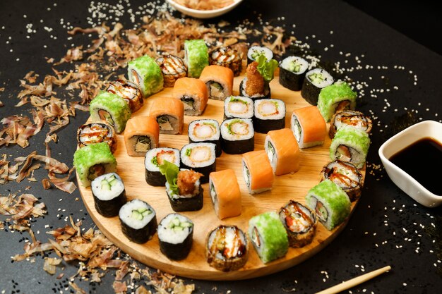 Sushi set with various types of sushi on wooden desk close-up view