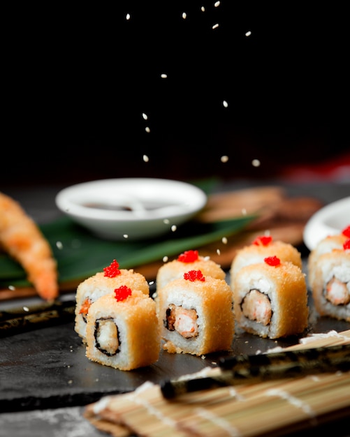 Sushi set with yellow caviar on the table