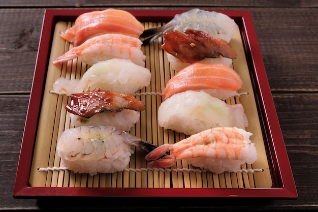 Sushi various assortment red bamboo tray