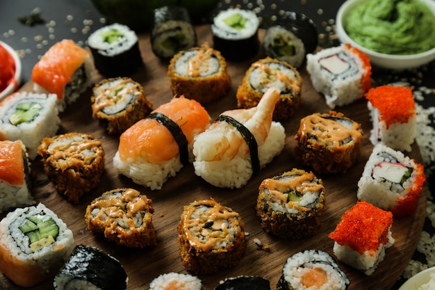 Sushi with cucumber, ginger, wasabi and sesame seeds