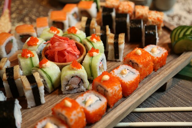 Sushi with cucumber, ginger, wasabi and sesame seeds