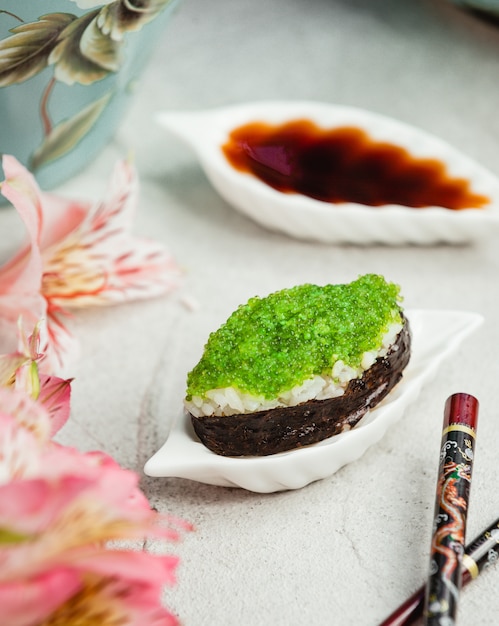 Sushi with rice and green caviar