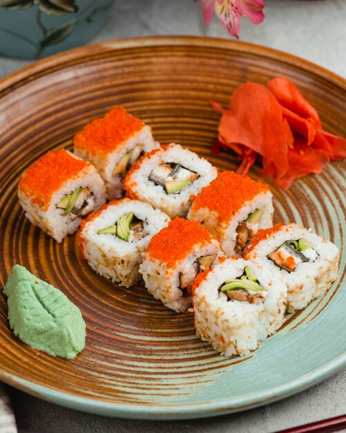 Sushi with rice red caviar ginger and wasabi