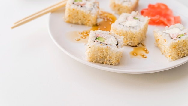 Sushi with sesame seeds on a plate