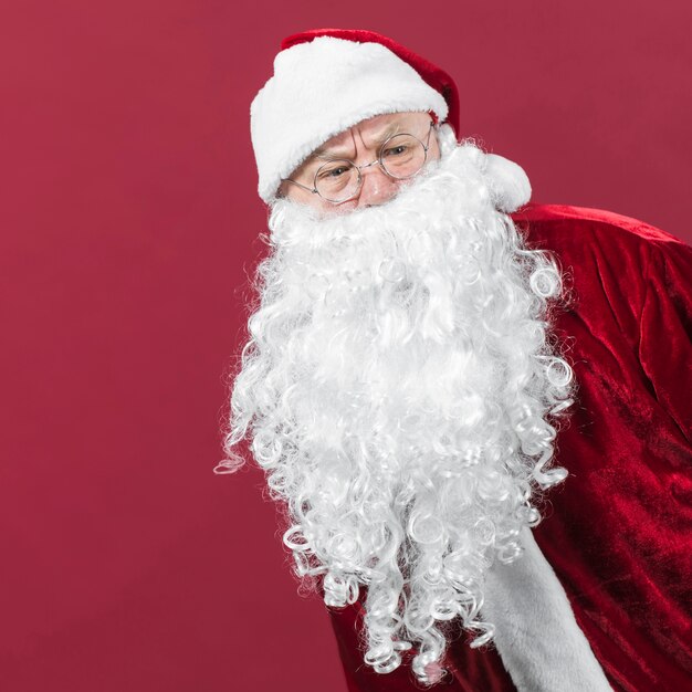 Suspicious Santa Claus in red costume