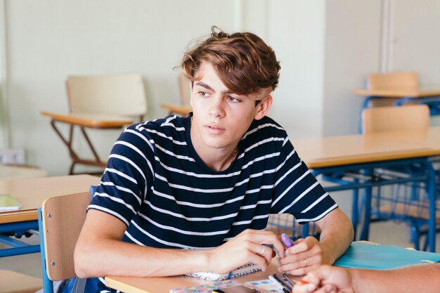 Sutdent sitting at his desk