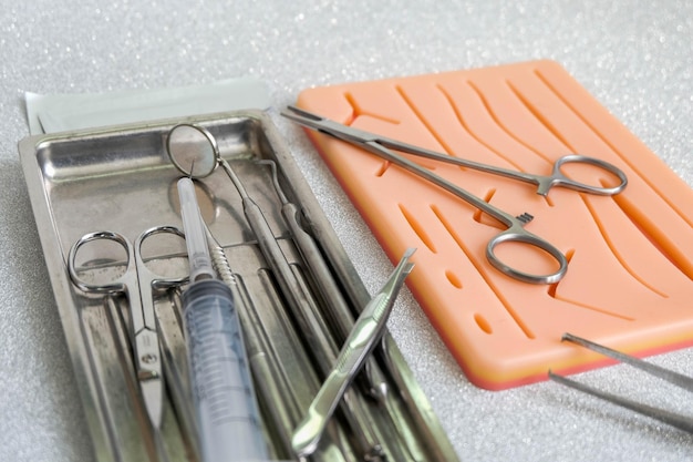 Free photo suturing human skin medical silicone pad and surgical instruments for practice