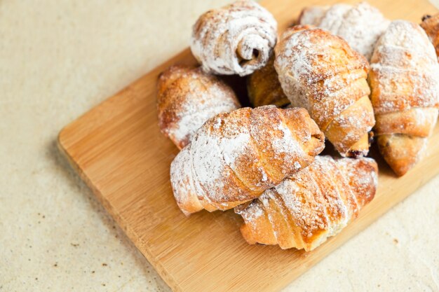 Sweet bagels on wooden cutting board.