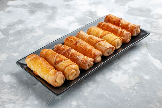 sweet bangles baked filled pastries inside black mold on light desk