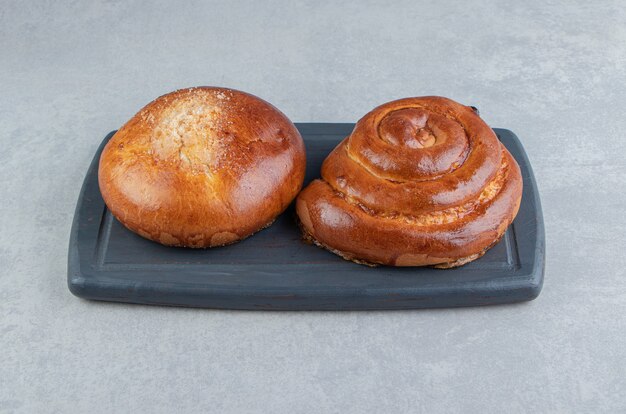 Sweet bun pastries on black board. 