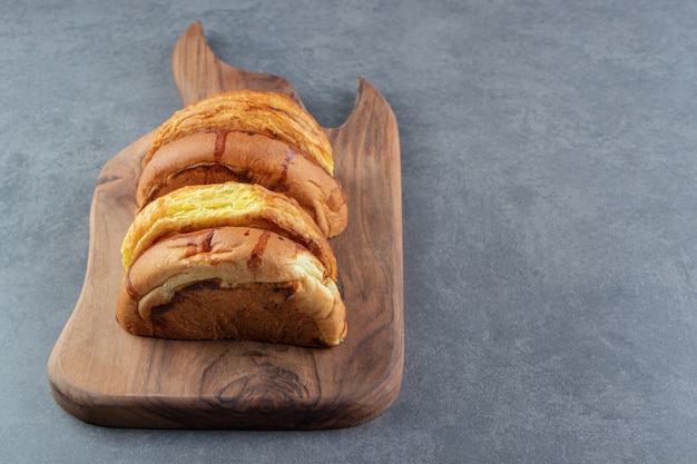 Sweet buns placed on wooden board. 