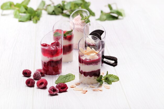 Sweet cakes in glasses with berries