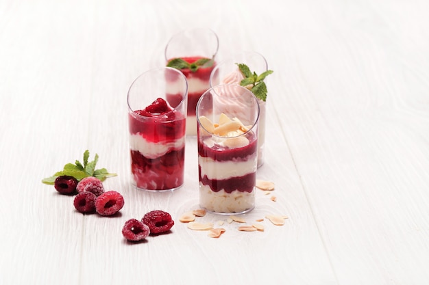 Sweet cakes in glasses with berries