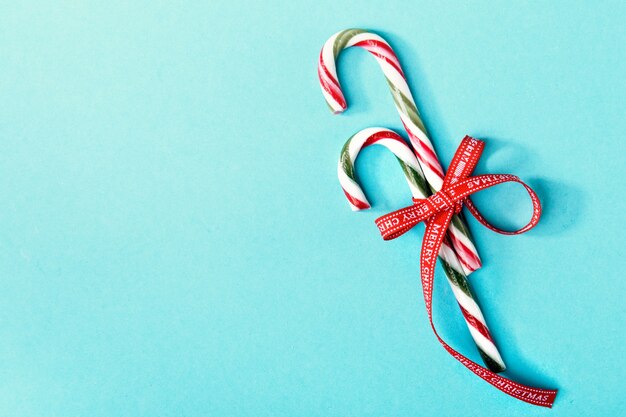 Sweet candy canes on blue