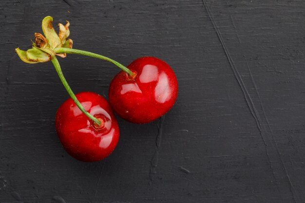 Sweet cherries on dark grey table, flat lay.