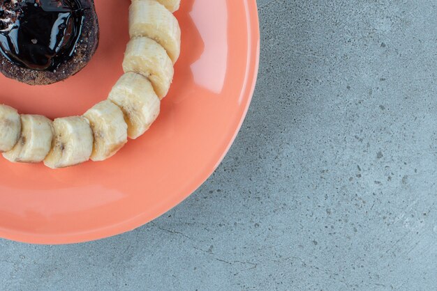 Sweet chocolate cake with slices of banana. 