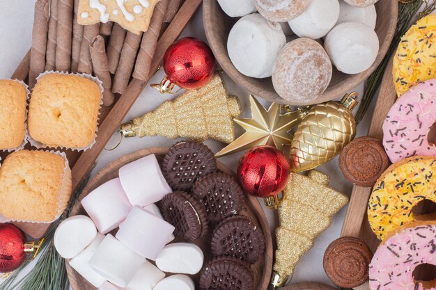 Sweet Christmas pastry with balls on white table .