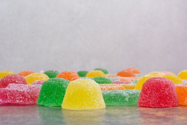 Sweet colorful jelly candy on marble background