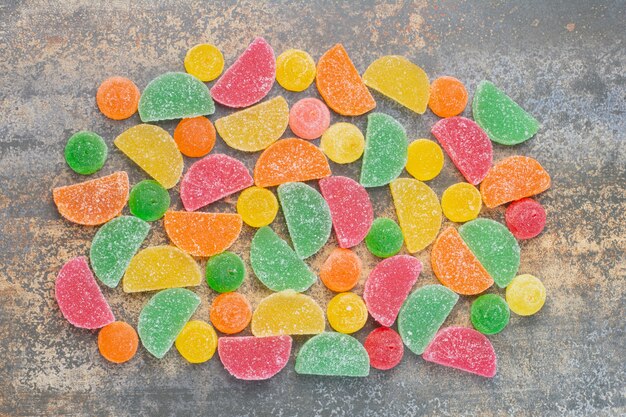 Sweet colorful jelly candy on marble background