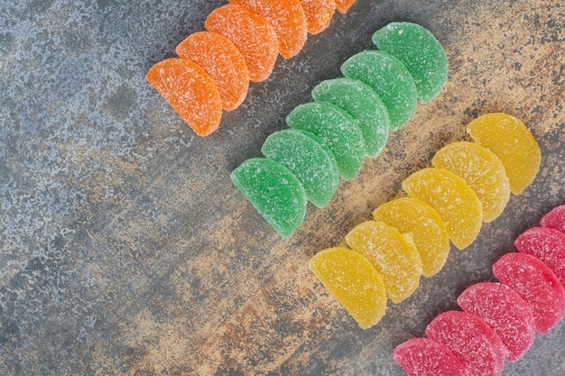 Sweet colorful jelly candy on marble background