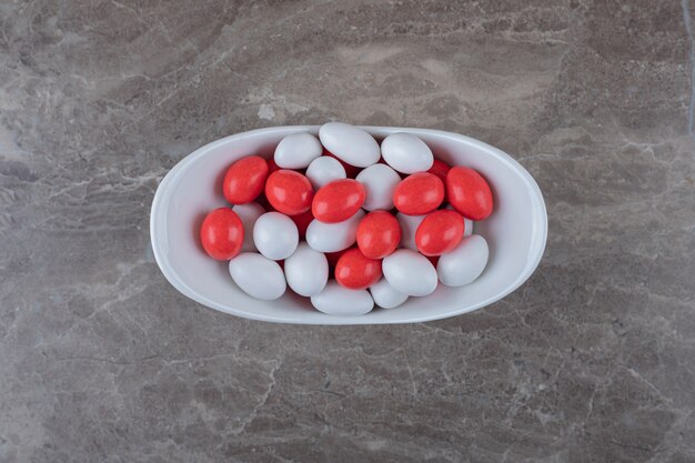 Sweet confectionery in the bowl  on the marble surface