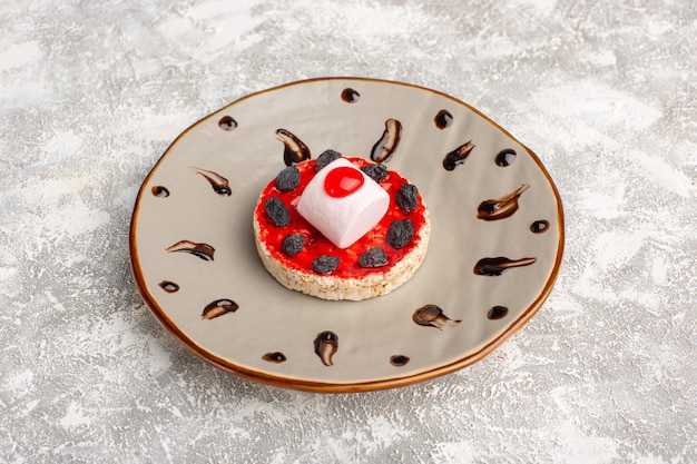 sweet cookie with cream dried fruits inside plate on grey