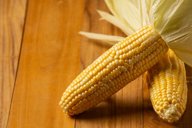 Sweet corn placed on a wooden floor.