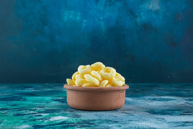 Sweet corn ring in a clay bowl , on the marble table.