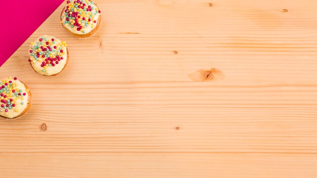 Sweet cupcake and pink paper