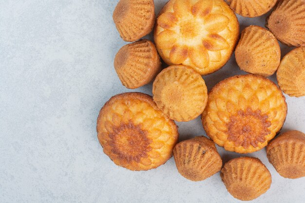 Sweet delicious cupcakes on white background