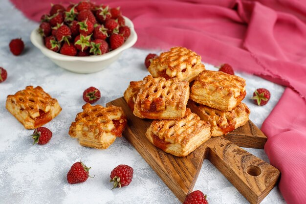 Sweet delicious raspberry cookies with ripe raspberries, top view