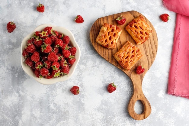 Sweet delicious raspberry cookies with ripe raspberries, top view