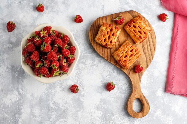 Sweet delicious raspberry cookies with ripe raspberries, top view