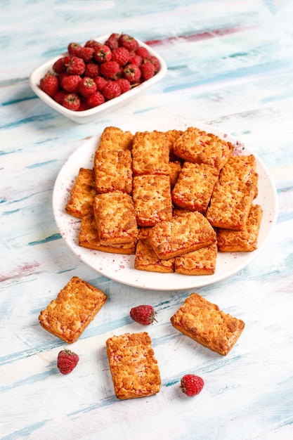 Free photo sweet delicious raspberry jam cookies with ripe raspberries,top view