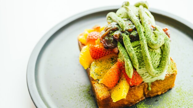 Sweet dessert bread toast with matcha ice cream and strawberry , orange