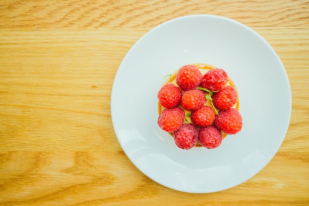 Sweet dessert custard tart with raspberry on top