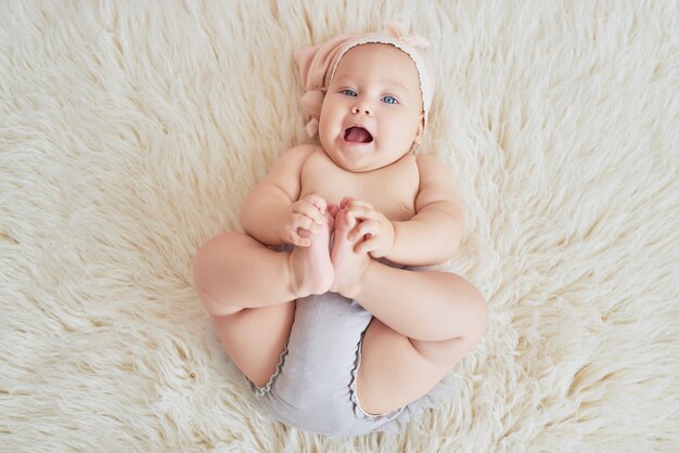 子供部屋のベッドの上の甘い面白い赤ちゃん 6ヶ月座ってクロールのかわいい女の子 プレミアム写真 子供部屋のベッドの上の甘い面白い赤ちゃん 6ヶ月座ってクロールのかわいい女の子 プレミアム写真