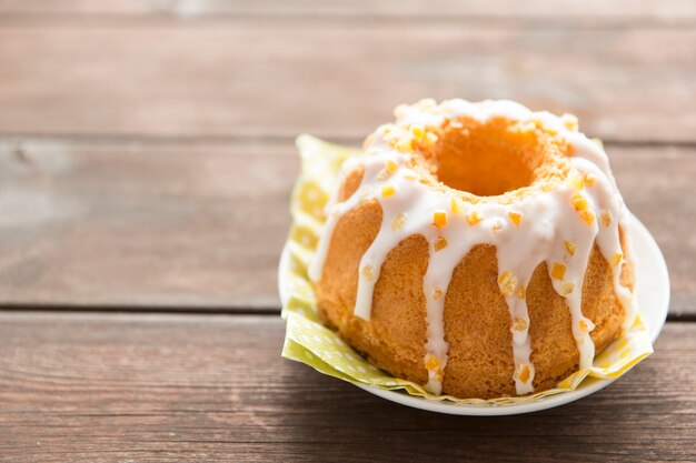 Sweet garnished Easter cake on wooden table