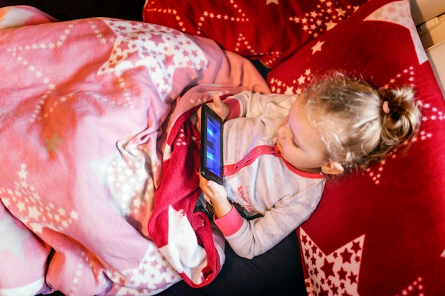 Free photo sweet girl playing game on smartphone