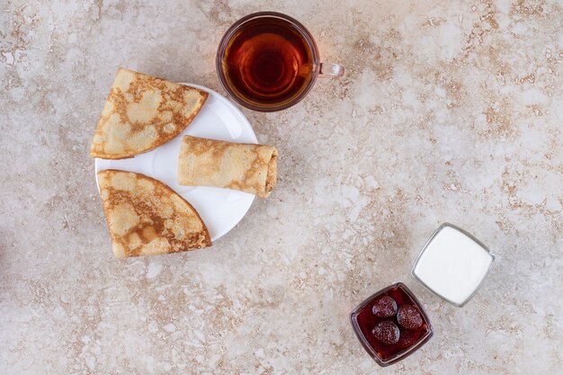 Sweet homemade crepes with a cup of hot tea