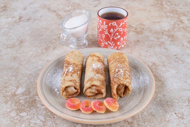 Sweet homemade crepes with a cup of hot tea